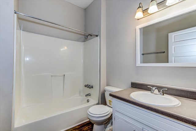 full bathroom with shower / washtub combination, vanity, wood-type flooring, and toilet