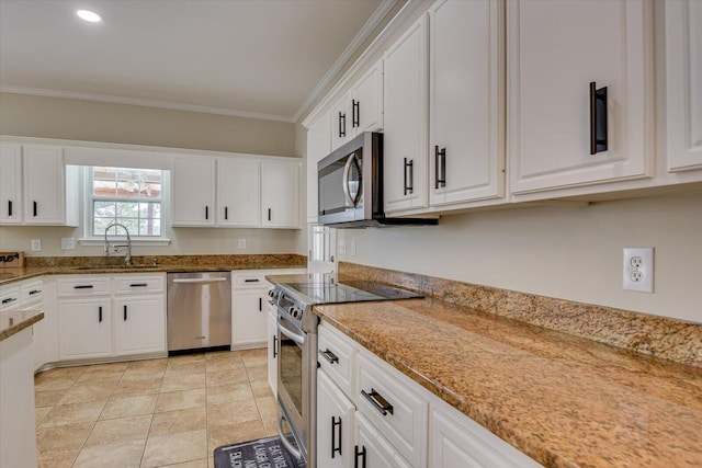 kitchen with light stone counters, crown molding, appliances with stainless steel finishes, white cabinets, and a sink