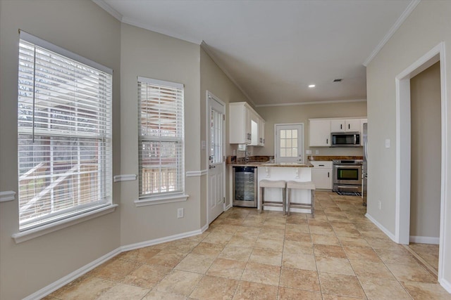 kitchen featuring beverage cooler, stainless steel appliances, baseboards, white cabinets, and crown molding