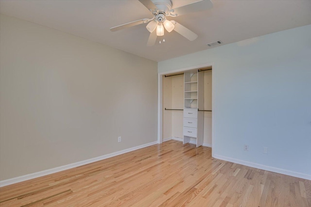 unfurnished bedroom featuring a ceiling fan, visible vents, baseboards, a closet, and light wood-type flooring