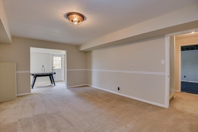 carpeted empty room featuring baseboards