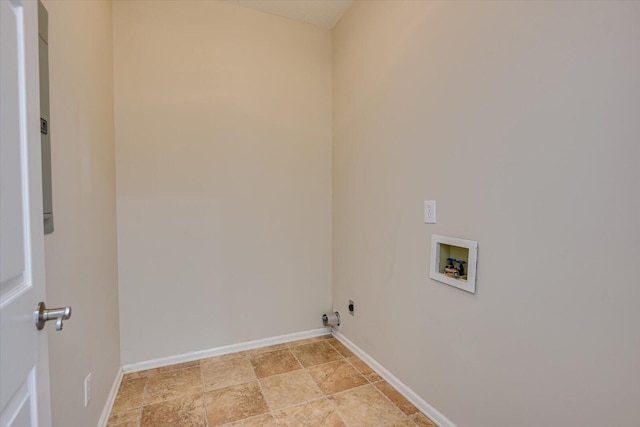 washroom with washer hookup, laundry area, stone finish flooring, and baseboards