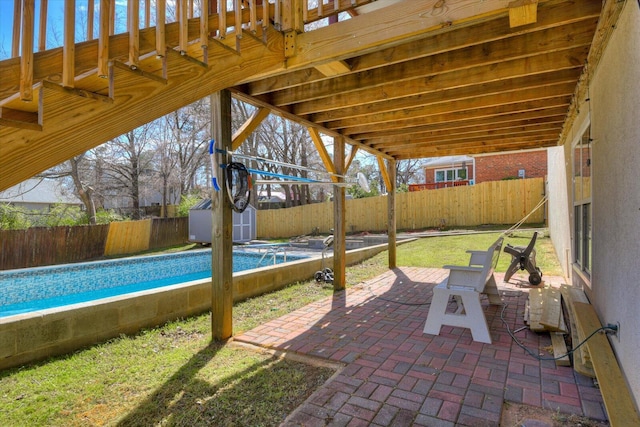 view of patio with a shed, a fenced in pool, a fenced backyard, and an outdoor structure