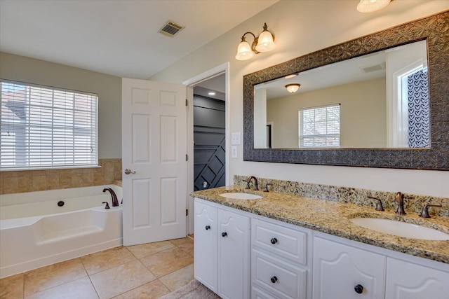 full bathroom with visible vents, a sink, and tile patterned floors