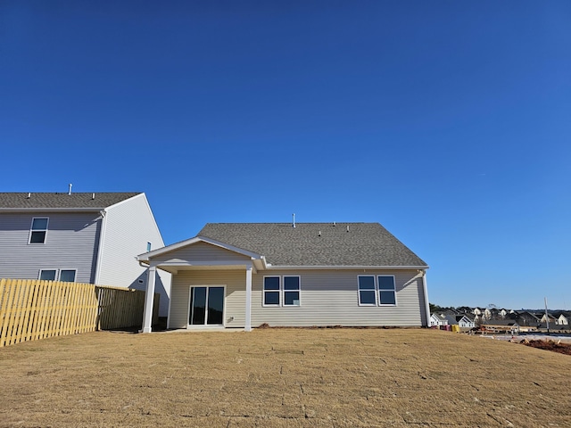 rear view of property with a yard