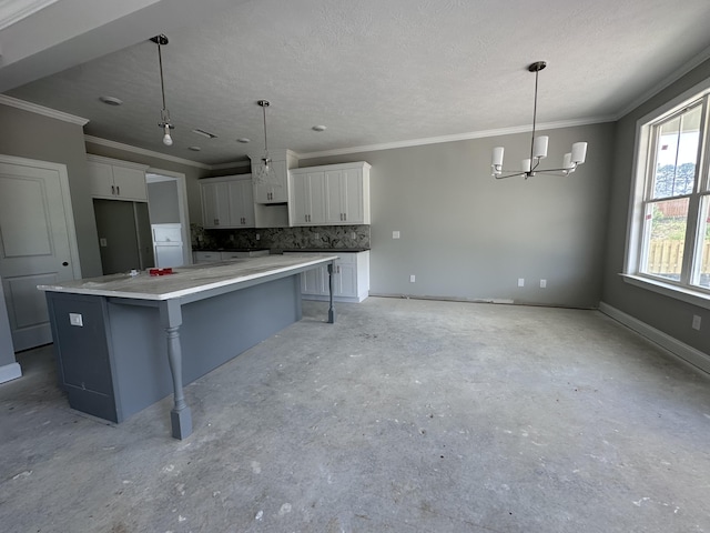 845 Lillian Park Dr, Grovetown, GA 30813 - kitchen featuring decorative backsplash, a chandelier, white cabinetry, a large island, and crown molding