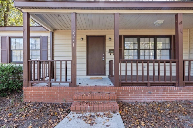 view of exterior entry with a porch