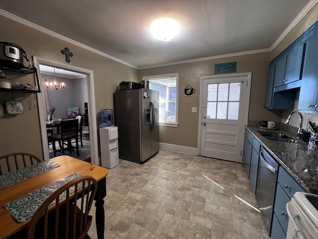 kitchen featuring blue cabinets, an inviting chandelier, appliances with stainless steel finishes, and a sink