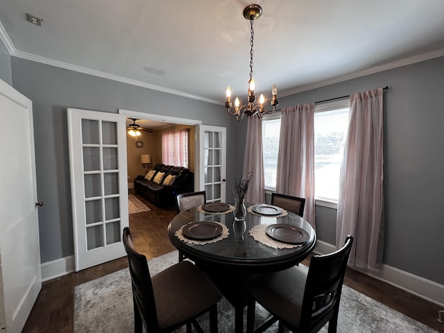 dining area featuring baseboards, an inviting chandelier, wood finished floors, and ornamental molding