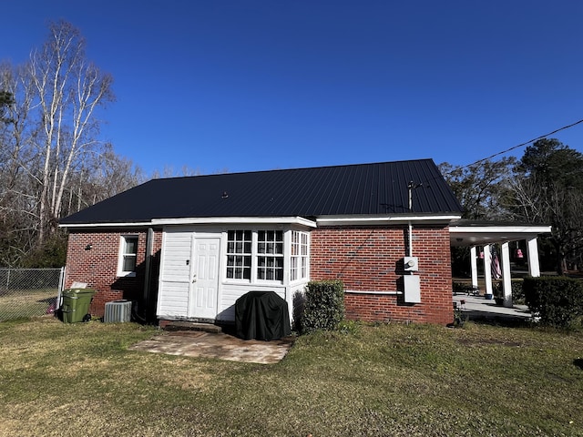 view of outbuilding featuring central AC and fence