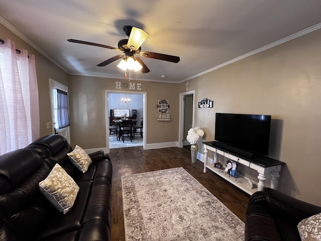 living area featuring a ceiling fan, wood finished floors, baseboards, and ornamental molding