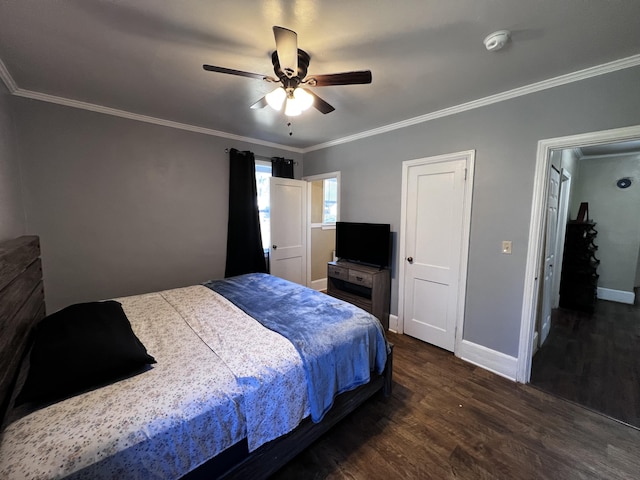 bedroom featuring baseboards, dark wood-type flooring, and crown molding