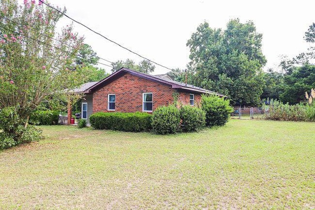 view of home's exterior with a lawn