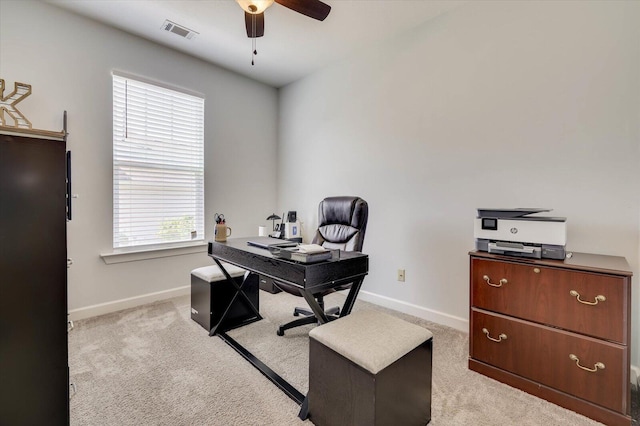 carpeted home office with ceiling fan