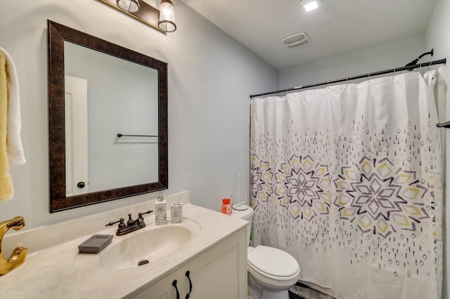 bathroom with a shower with curtain, vanity, and toilet