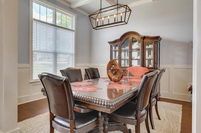 dining room featuring beamed ceiling, dark wood-type flooring, and a notable chandelier