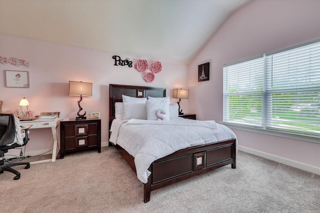 carpeted bedroom with lofted ceiling