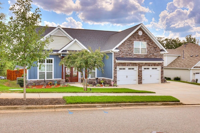 craftsman-style home with french doors and a garage