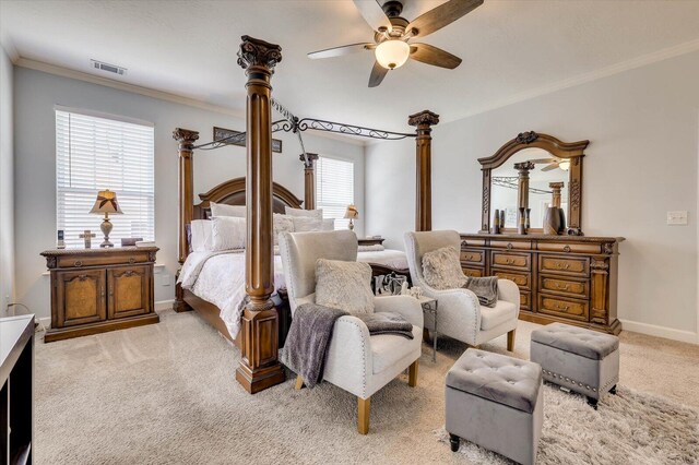carpeted bedroom with multiple windows, ceiling fan, and ornamental molding