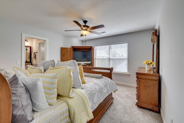 carpeted bedroom featuring ceiling fan and a textured ceiling