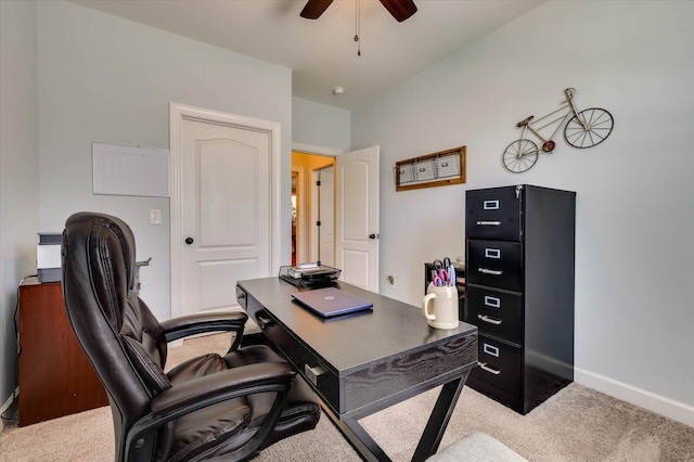 carpeted home office featuring ceiling fan