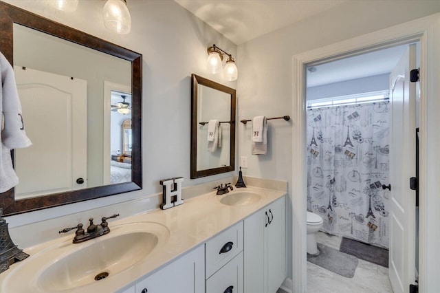 bathroom featuring ceiling fan, vanity, a shower with shower curtain, and toilet