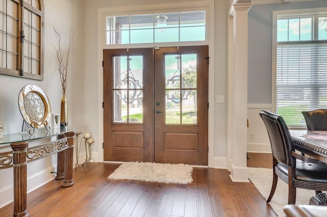 foyer entrance with hardwood / wood-style floors and french doors