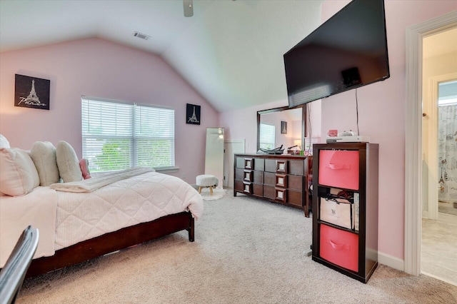 carpeted bedroom featuring ensuite bathroom, ceiling fan, and lofted ceiling