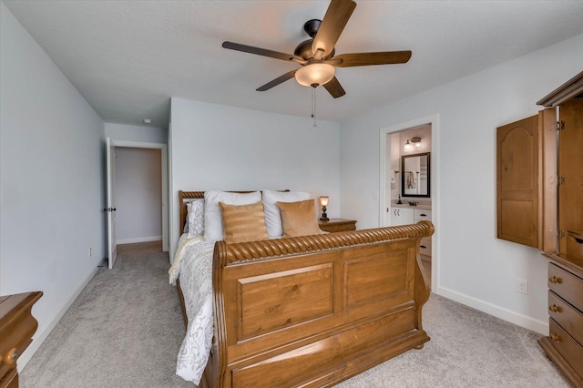 carpeted bedroom featuring ensuite bathroom and ceiling fan