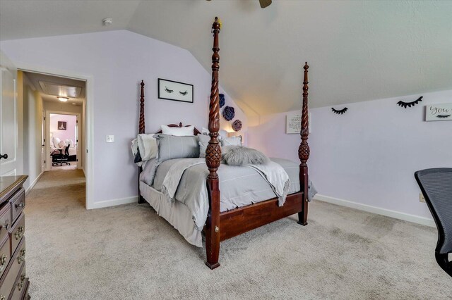 carpeted bedroom featuring lofted ceiling