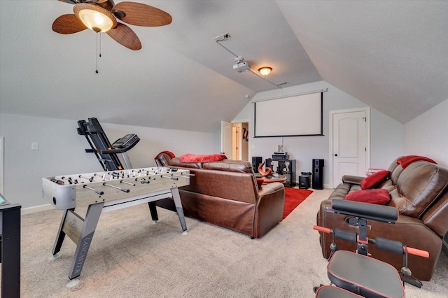 carpeted cinema featuring ceiling fan and vaulted ceiling