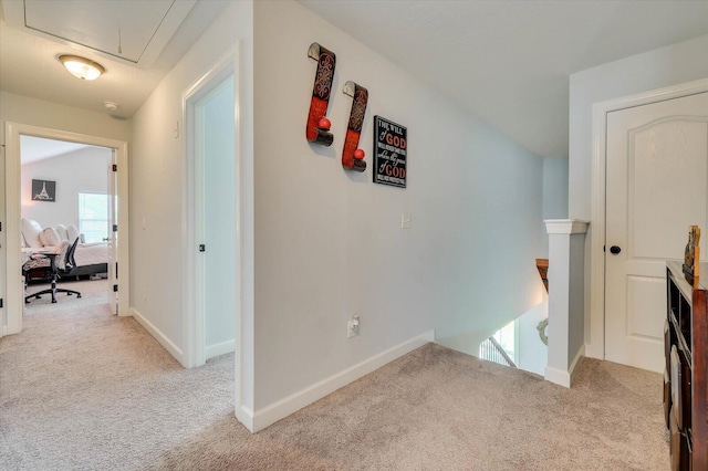 hall with light colored carpet