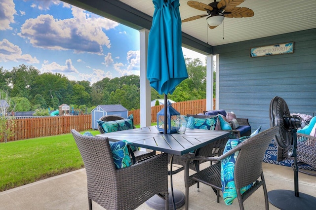 view of patio with ceiling fan and a storage shed