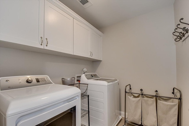 laundry room with cabinets and independent washer and dryer