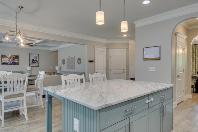 kitchen featuring a kitchen breakfast bar, a center island, decorative light fixtures, and light hardwood / wood-style flooring