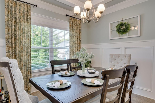 dining room featuring crown molding, a chandelier, and hardwood / wood-style flooring