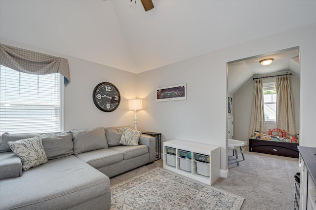 carpeted living room featuring ceiling fan and vaulted ceiling