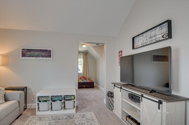 carpeted living room with vaulted ceiling