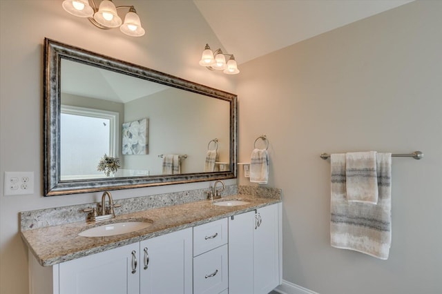 bathroom with vanity and lofted ceiling