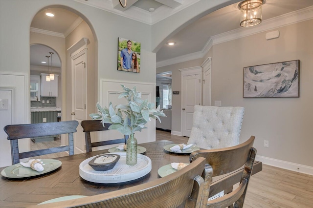 dining room featuring light hardwood / wood-style flooring and crown molding