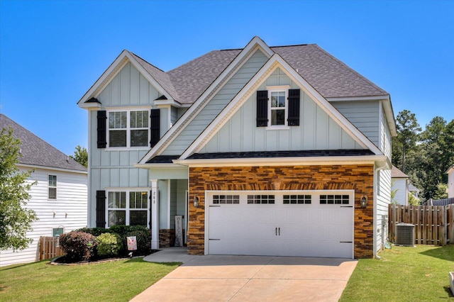 craftsman house featuring a front yard, a garage, and central air condition unit