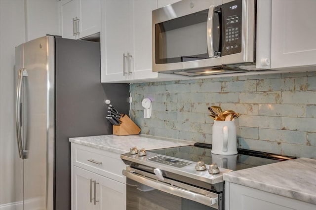 kitchen featuring backsplash, white cabinetry, and appliances with stainless steel finishes