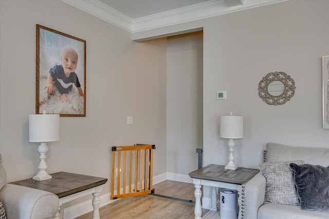 living area featuring hardwood / wood-style floors and ornamental molding