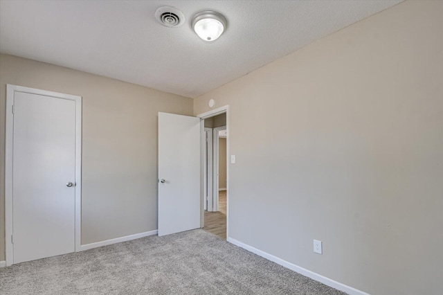 unfurnished bedroom featuring light colored carpet