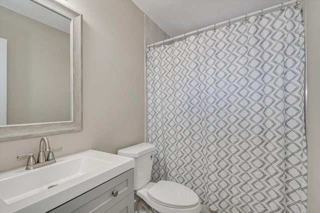 bathroom featuring vanity, toilet, and a shower with curtain