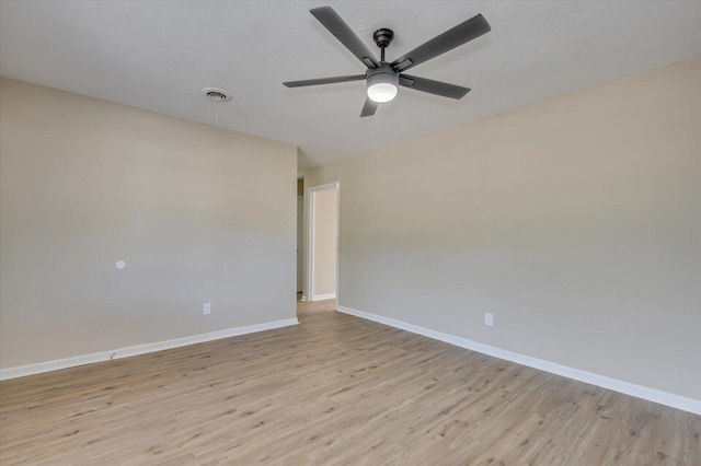 unfurnished room with ceiling fan, a textured ceiling, and light wood-type flooring