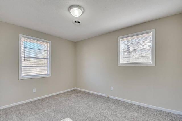 spare room featuring light colored carpet