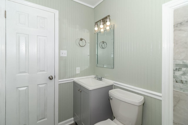 bathroom featuring vanity, crown molding, and toilet