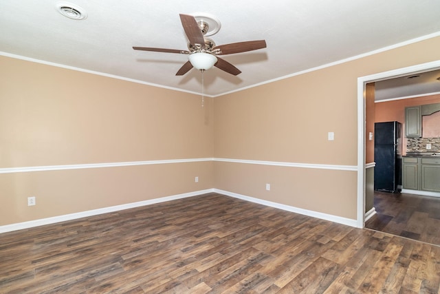 unfurnished room featuring dark hardwood / wood-style flooring, ornamental molding, and ceiling fan