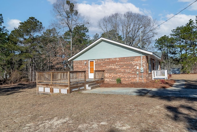 view of side of property with a wooden deck